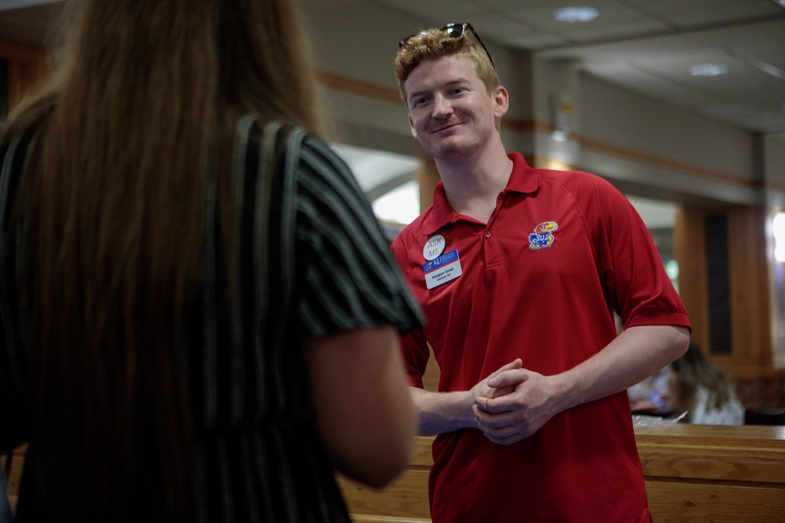 Student orientation assistant smiling at another student